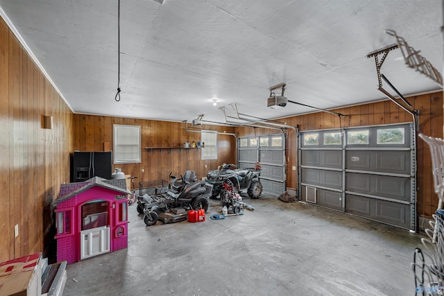 garage featuring wood walls, black fridge with ice dispenser, and a garage door opener