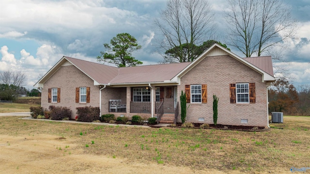 ranch-style house featuring central AC unit, a porch, and a front yard