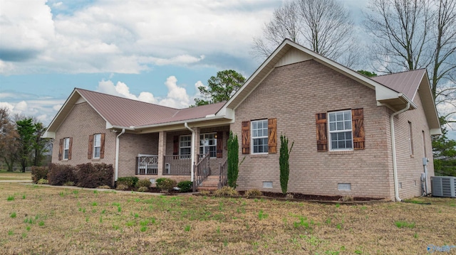 view of front of home with a porch, central AC, and a front lawn