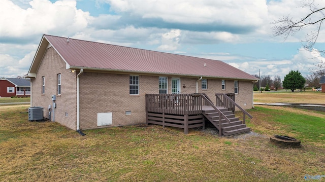 back of house with a yard, cooling unit, and a deck