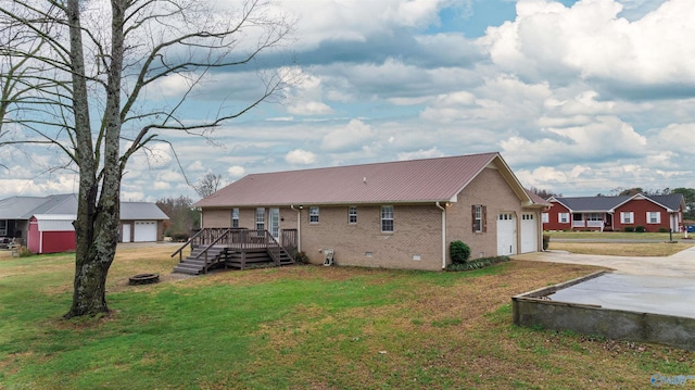 back of property featuring a yard, a garage, and a wooden deck