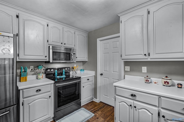 kitchen with white cabinets, dark hardwood / wood-style flooring, and stainless steel appliances