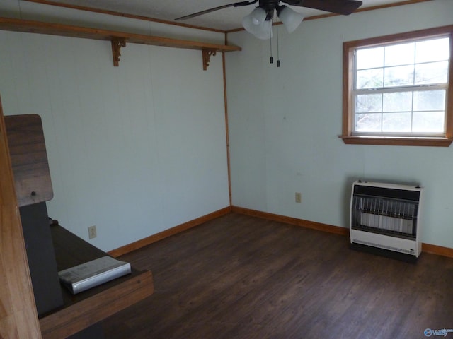 unfurnished room with heating unit, ceiling fan, and dark wood-type flooring