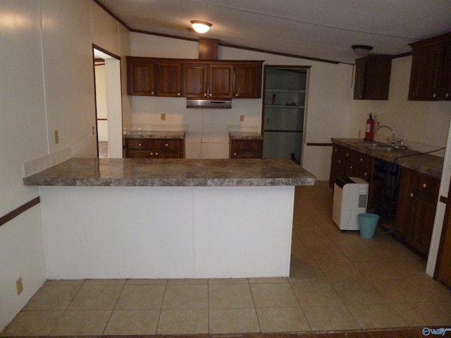 kitchen with light tile patterned floors, kitchen peninsula, dishwasher, vaulted ceiling, and sink