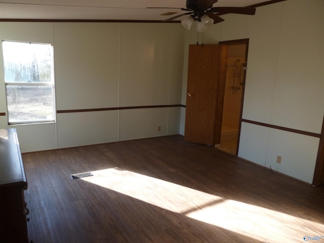 empty room with ceiling fan and dark wood-type flooring