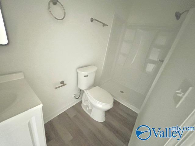 2618 NW Mountain Park Cir, Huntsville, AL 35810 - full bath featuring wood finished floors, vanity, and a shower