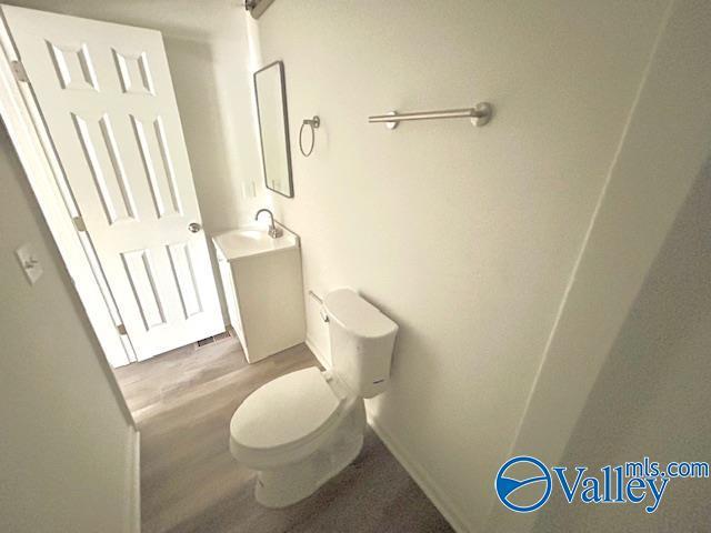 2618 NW Mountain Park Cir, Huntsville, AL 35810 - half bathroom with vanity and wood finished floors