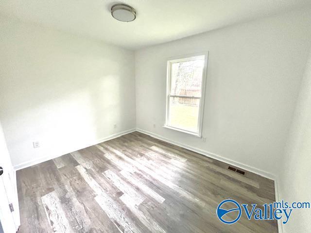 2618 NW Mountain Park Cir, Huntsville, AL 35810 - spare room featuring wood finished floors and baseboards