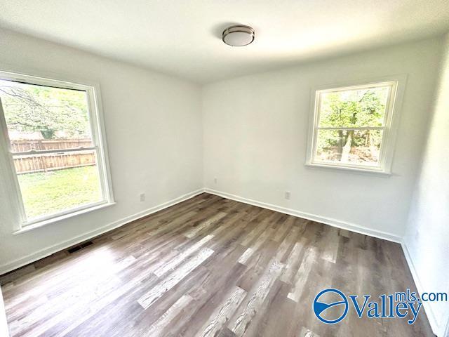 2618 NW Mountain Park Cir, Huntsville, AL 35810 - unfurnished room with healthy amount of natural light and dark wood-type flooring