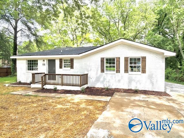 2618 NW Mountain Park Cir, Huntsville, AL 35810 - ranch-style home with brick siding, a wooden deck, and view of scattered trees