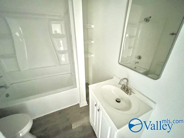 2618 NW Mountain Park Cir, Huntsville, AL 35810 - full bathroom with vanity, shower / bathtub combination, and wood finished floors