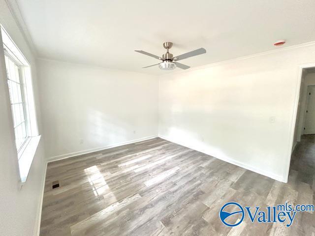 2618 NW Mountain Park Cir, Huntsville, AL 35810 - unfurnished room with ceiling fan, wood finished floors, and ornamental molding