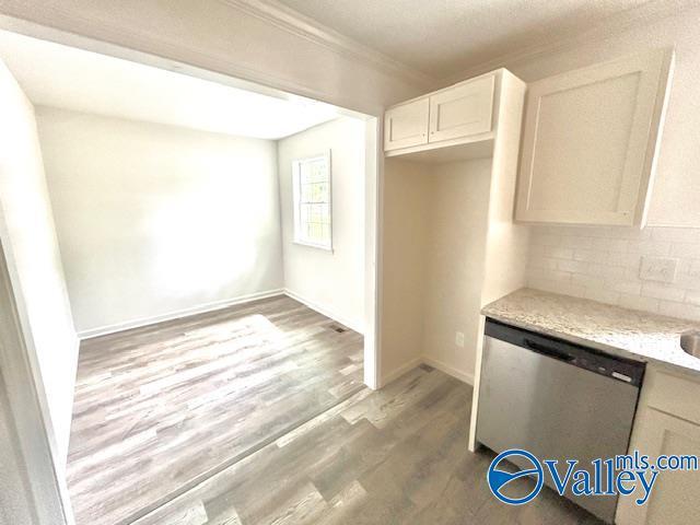2618 NW Mountain Park Cir, Huntsville, AL 35810 - kitchen with dishwasher, backsplash, light wood-style flooring, ornamental molding, and light stone counters