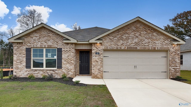 view of front of house with a garage and a front lawn