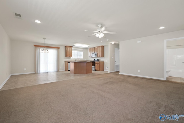 unfurnished living room featuring visible vents, baseboards, light colored carpet, ceiling fan with notable chandelier, and recessed lighting