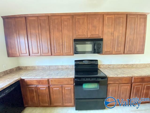 kitchen with black appliances and brown cabinetry