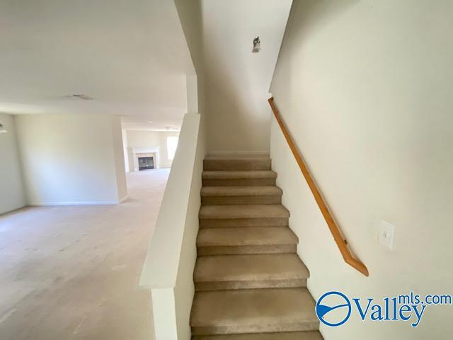 stairway featuring a fireplace