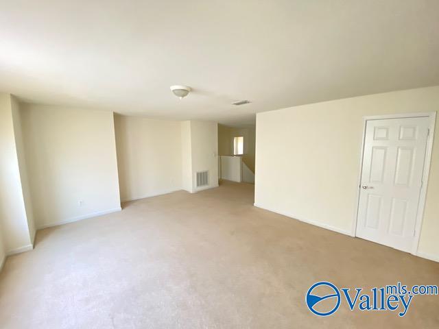 spare room with carpet and visible vents