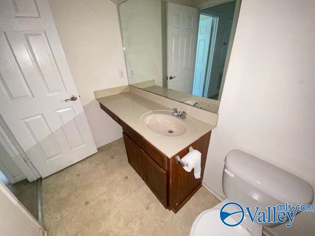 half bath with vanity and toilet