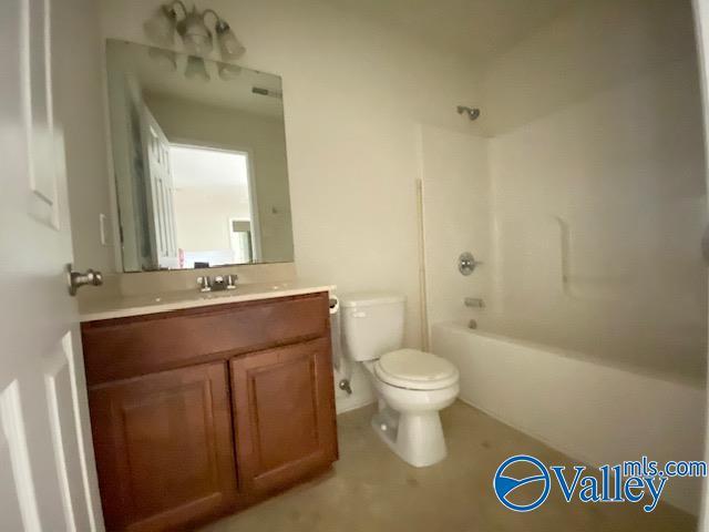 bathroom featuring toilet, shower / tub combination, and vanity