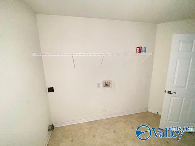 washroom featuring laundry area, baseboards, and washer hookup