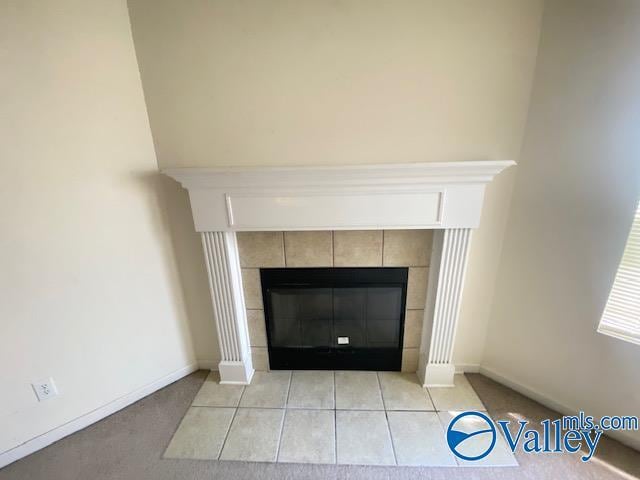 room details with baseboards and a tile fireplace