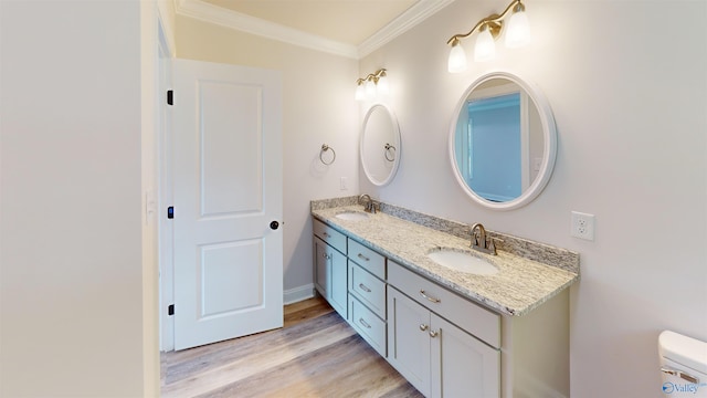 13680 Grigsby Ferry Rd, Elkmont, AL 35620 - bathroom featuring crown molding, double vanity, wood finished floors, and toilet