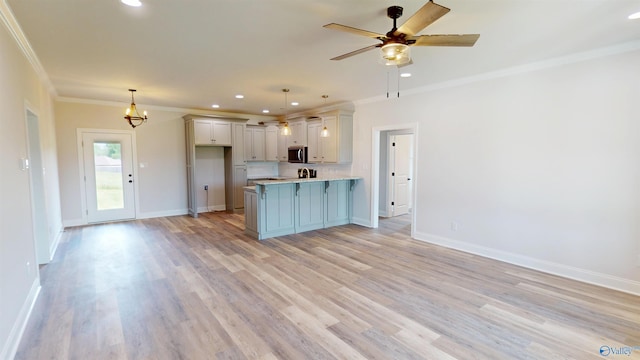 13680 Grigsby Ferry Rd, Elkmont, AL 35620 - kitchen with stainless steel microwave, ornamental molding, a peninsula, recessed lighting, and light countertops
