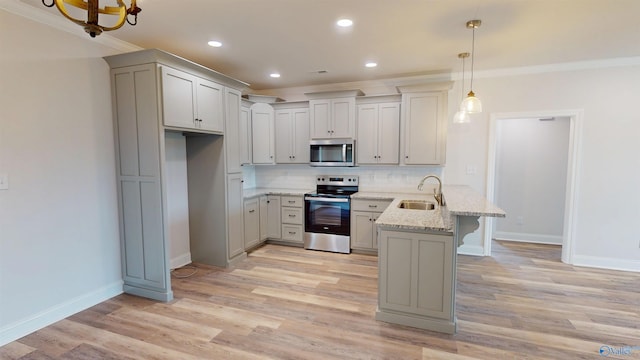 13680 Grigsby Ferry Rd, Elkmont, AL 35620 - kitchen with appliances with stainless steel finishes, a peninsula, a sink, ornamental molding, and a kitchen bar