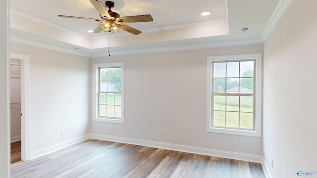 13680 Grigsby Ferry Rd, Elkmont, AL 35620 - spare room featuring a tray ceiling, light wood-style floors, ceiling fan, baseboards, and ornamental molding