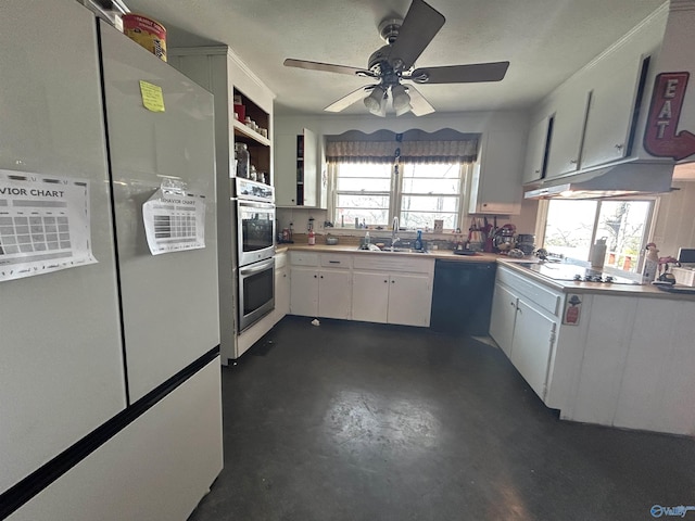 kitchen featuring finished concrete flooring, white cabinets, a sink, ceiling fan, and black appliances