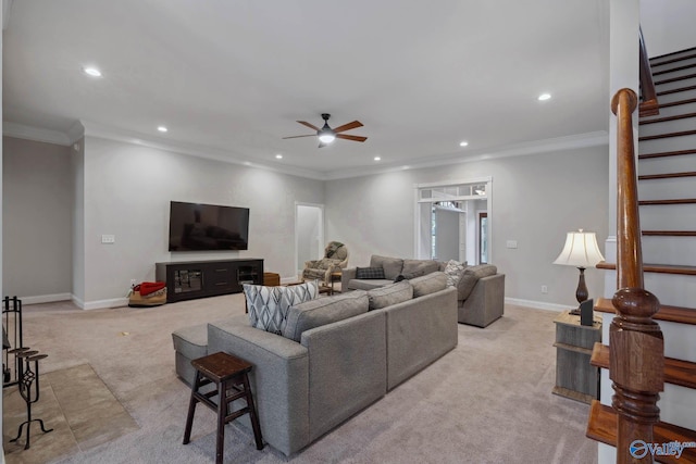 living room with ornamental molding, light colored carpet, stairway, and baseboards