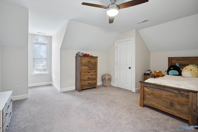 bedroom featuring light colored carpet, visible vents, vaulted ceiling, and baseboards