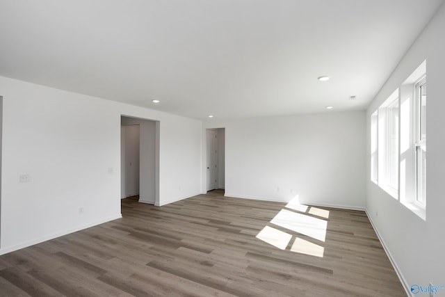 unfurnished room with light wood-type flooring