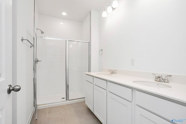 bathroom featuring vanity, tile patterned floors, and walk in shower