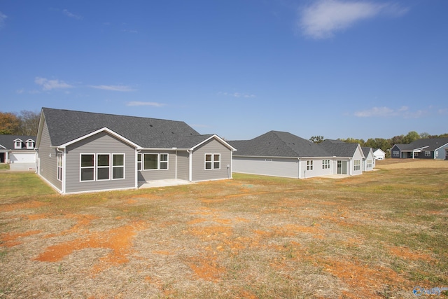 back of house with a yard