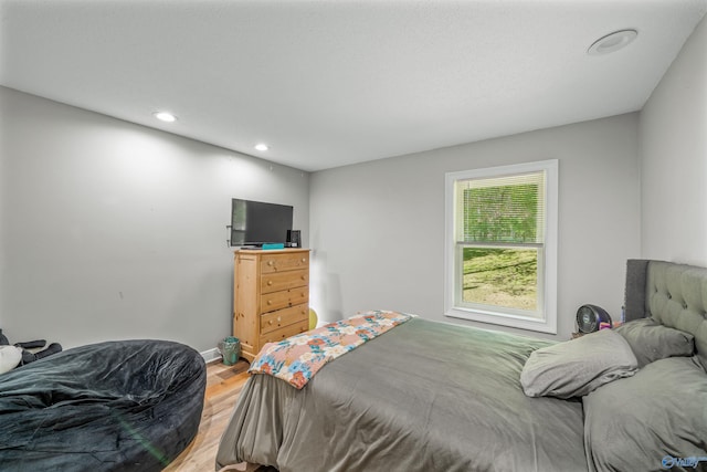 bedroom with hardwood / wood-style flooring