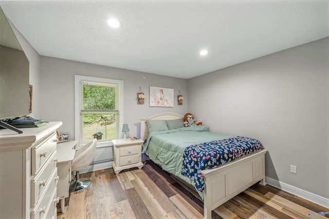 bedroom with wood-type flooring