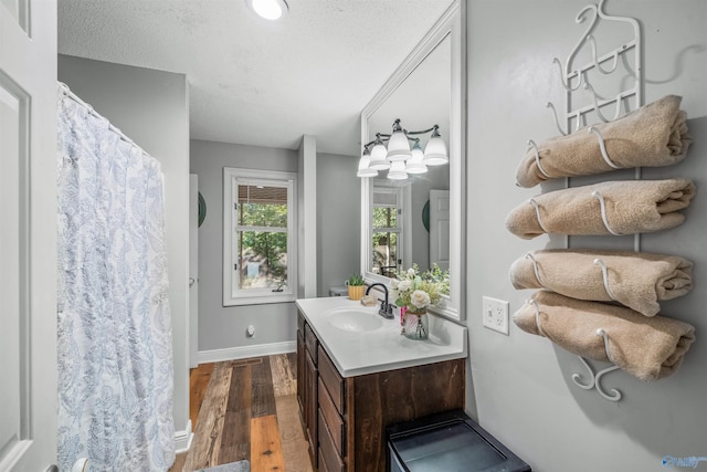 bathroom featuring vanity, hardwood / wood-style floors, and a textured ceiling