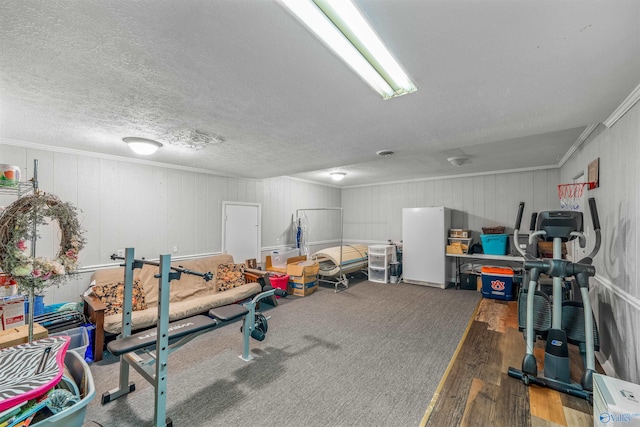 interior space with crown molding, wood walls, hardwood / wood-style floors, and a textured ceiling