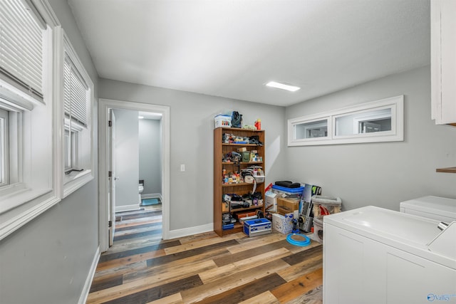 clothes washing area featuring wood-type flooring and washing machine and clothes dryer