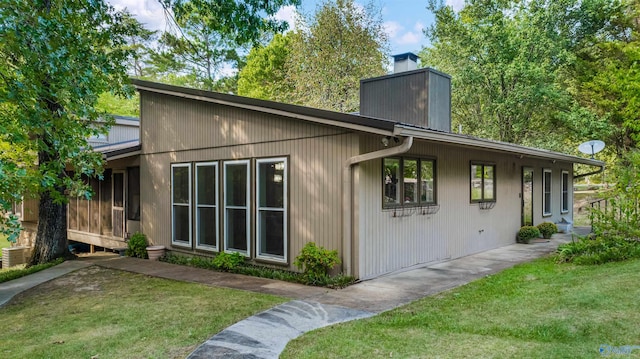 rear view of property with a lawn