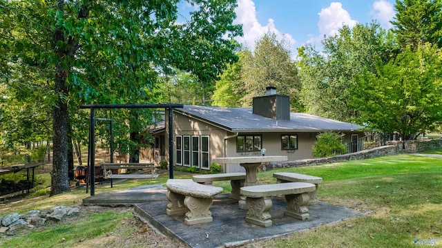 exterior space with a patio and a lawn