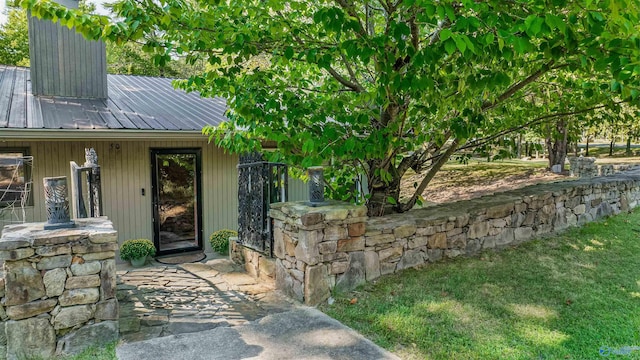 entrance to property featuring a lawn