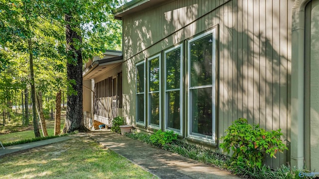 view of side of home with a lawn