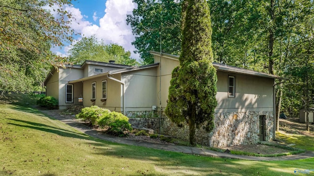 rear view of property with a lawn