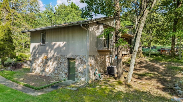 view of side of home featuring central AC