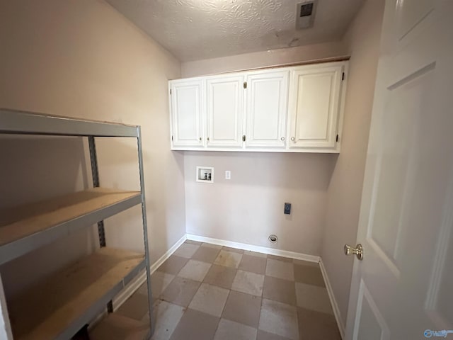 203 Lincoln Ave, Muscle Shoals, AL 35661 - washroom with electric dryer hookup, washer hookup, cabinet space, baseboards, and tile patterned floors