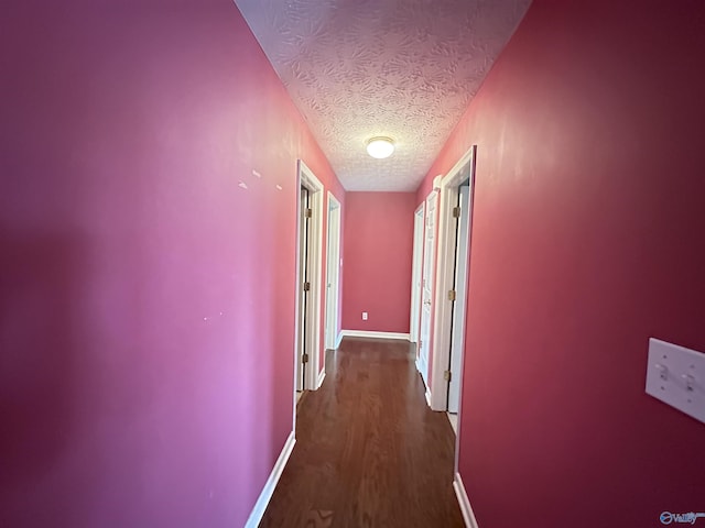 203 Lincoln Ave, Muscle Shoals, AL 35661 - hallway featuring a textured ceiling, dark wood-style floors, and baseboards