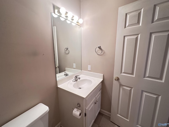 203 Lincoln Ave, Muscle Shoals, AL 35661 - bathroom with toilet, vanity, and tile patterned floors